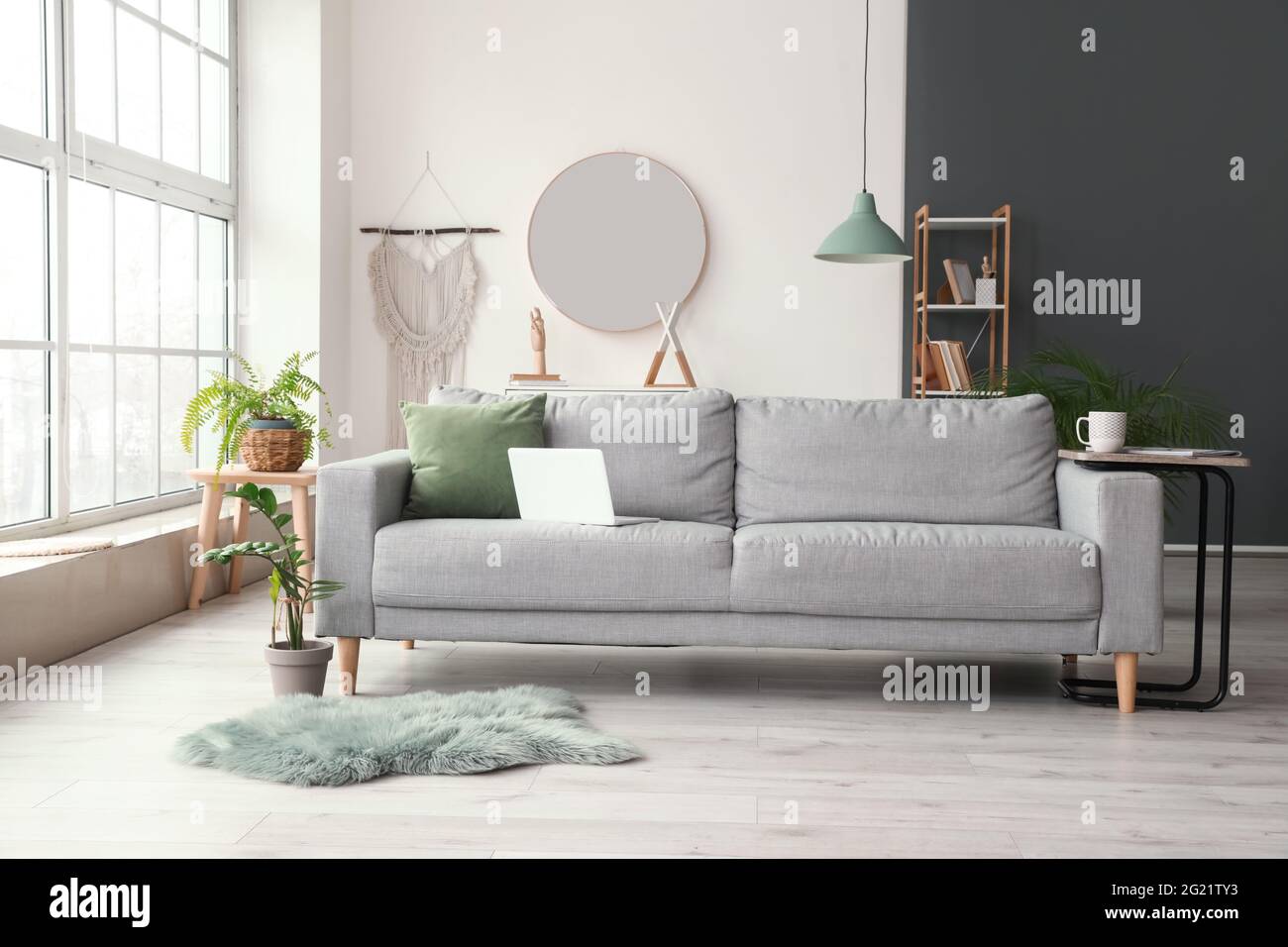 Stylish interior of living room with comfortable sofa Stock Photo - Alamy