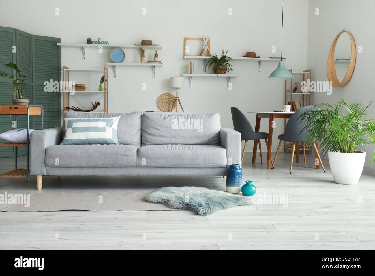 Stylish interior of living room with comfortable sofa Stock Photo - Alamy