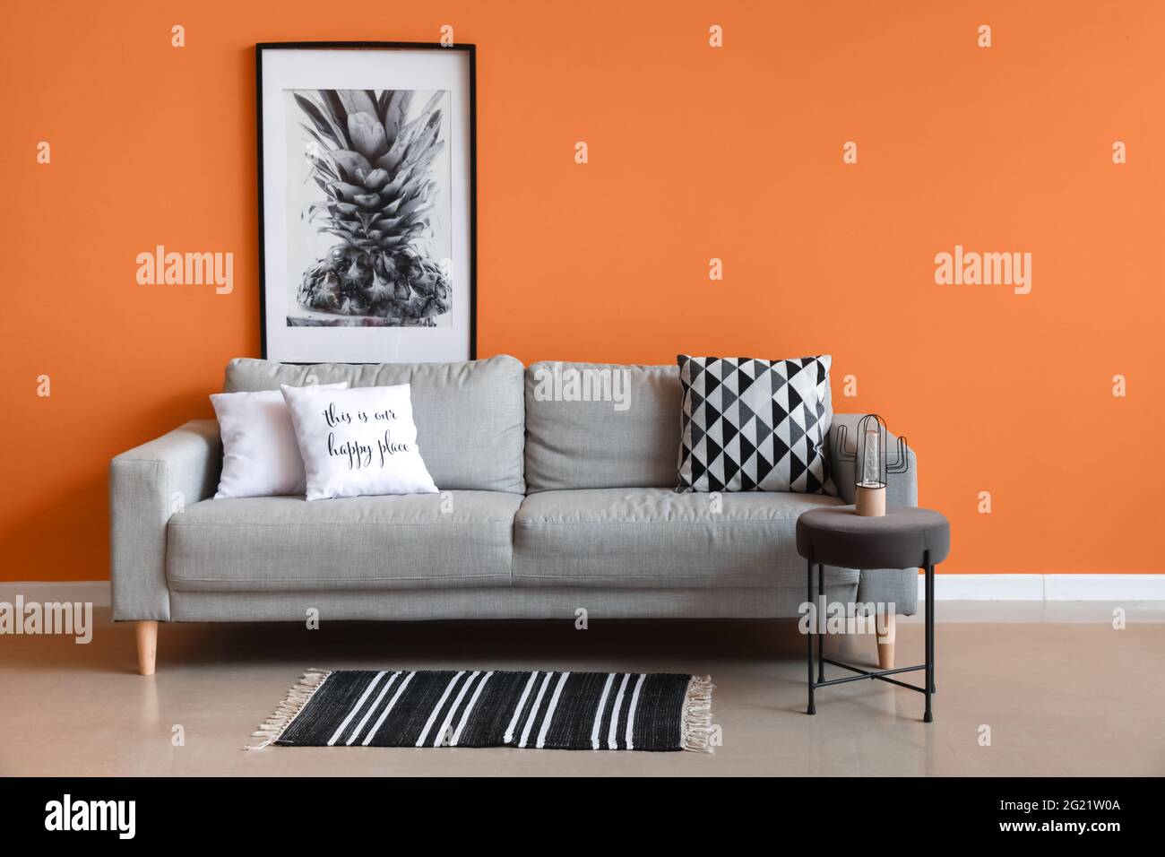 Stylish interior of living room with cozy sofa Stock Photo - Alamy
