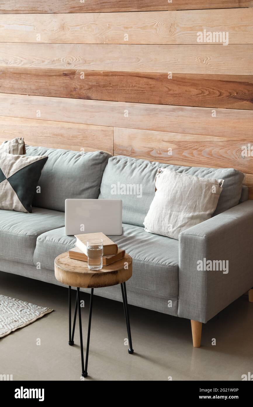 Stylish interior of living room with cozy sofa Stock Photo - Alamy