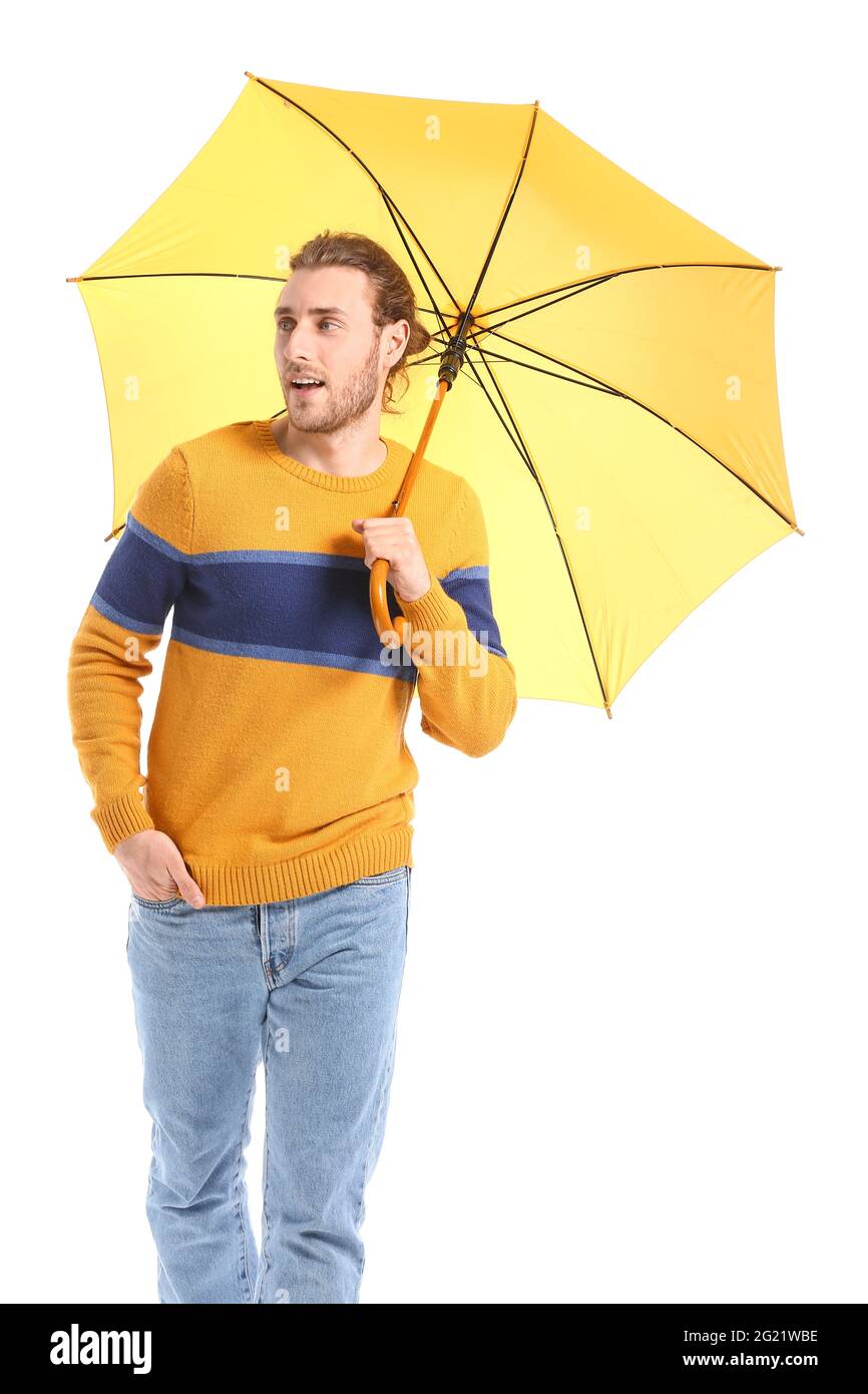 Handsome young man with umbrella on white background Stock Photo - Alamy