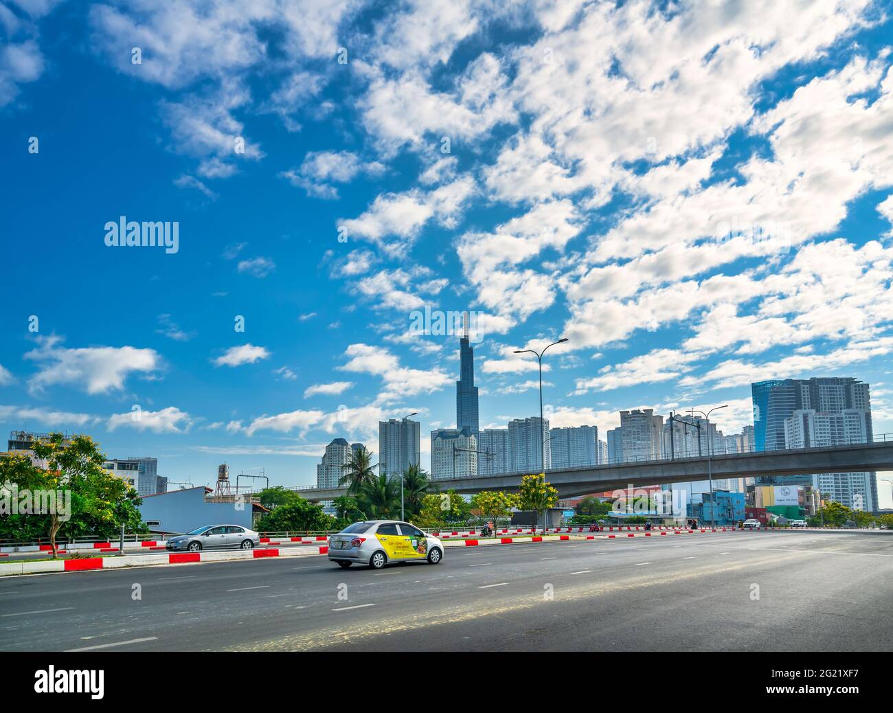 Picture of Traffic on the bridge next to the riverside high-rise urban area ...
