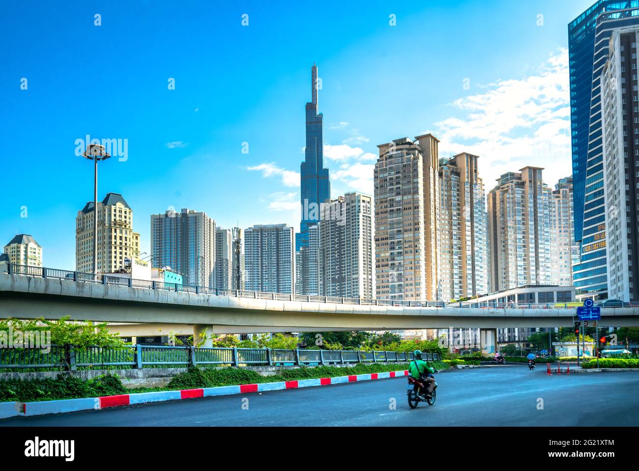Picture of Traffic on the bridge next to the riverside high-rise urban area ...