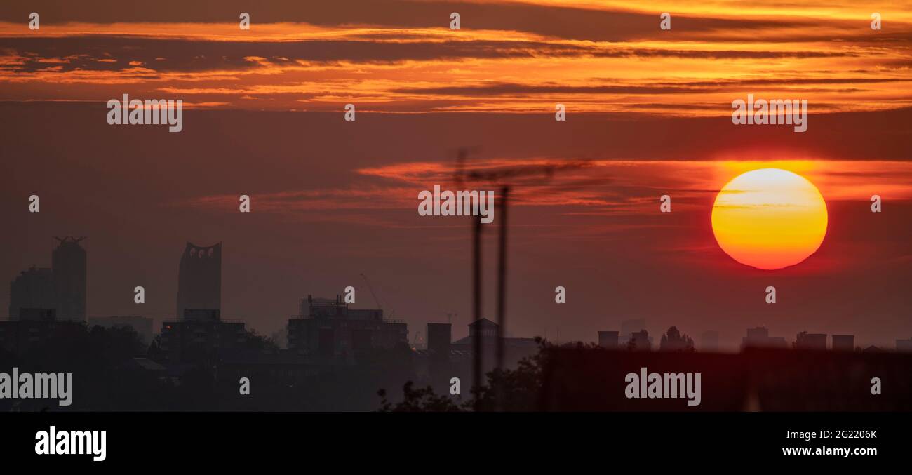 London, UK. 8 June 2021. The Sun rises at 04.46am through cloud before another fine day of weather in the capital. Temperatures in London are due to climb to 26 degrees by the weekend. Credit: Malcolm Park/Alamy Live News. Stock Photo