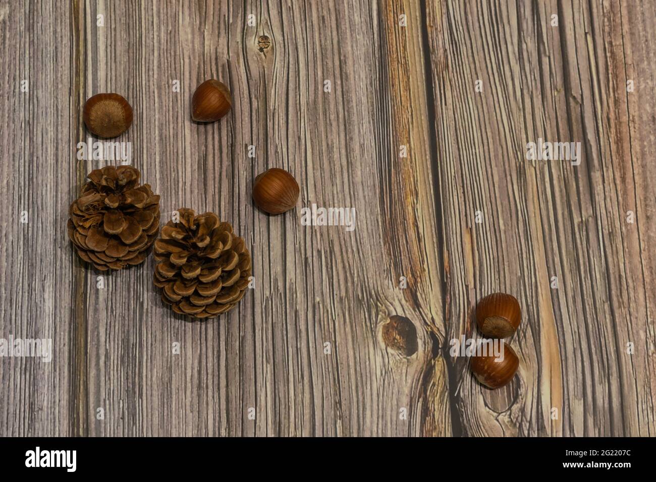 pine cones scattered on wooden background Stock Photo