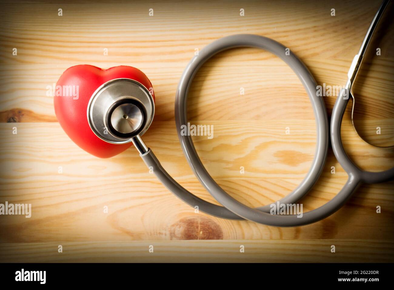 Stethoscope with red heart on a wood background Stock Photo - Alamy