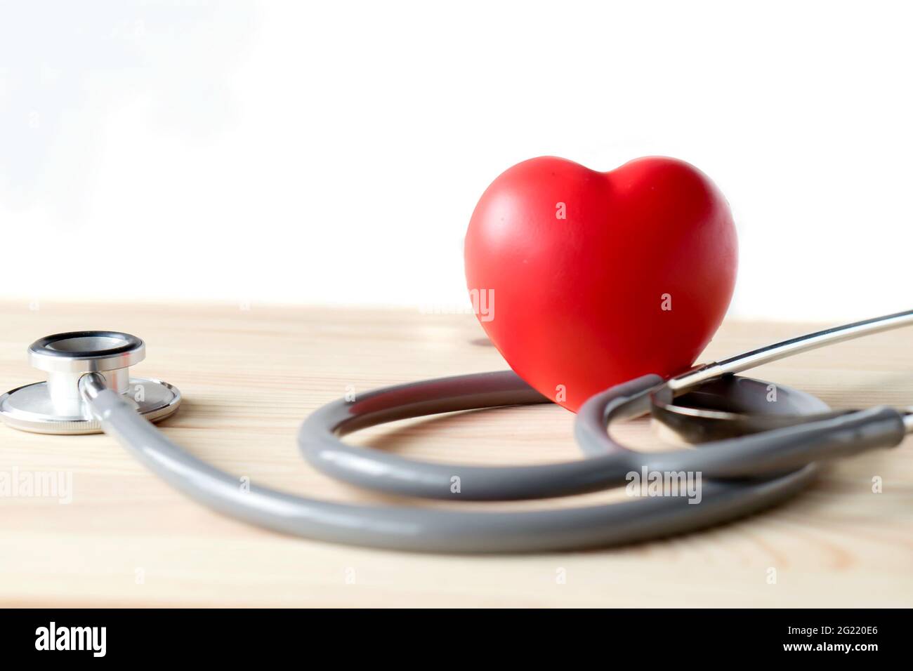 Stethoscope with red heart on a wood background Stock Photo - Alamy
