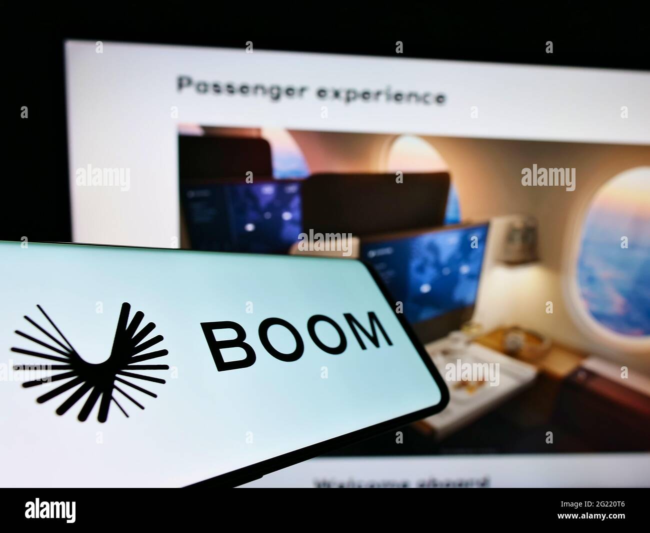 Mobile phone with logo of US aerospace company Boom Technology Inc (Supersonic) on screen in front of website. Focus on center-left of phone display. Stock Photo