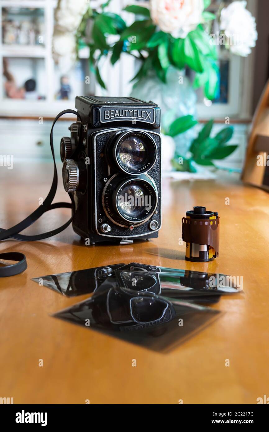 Vintage retro Beautyflex twin lens reflex camera with old negatives and  film in a domestic setting Stock Photo - Alamy