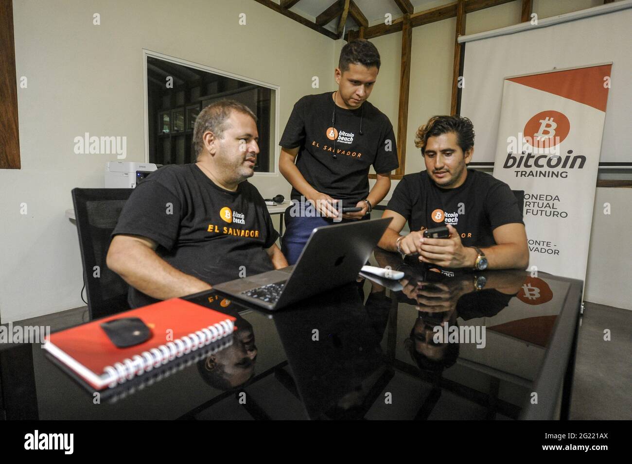 Chiltuipan, El Salvador. 07th June, 2021. A five US Dollar bill is seen  next to a phone displaying an application used to transfer Bitcoin.  Salvadoran President Nayib Bukele has announced that he