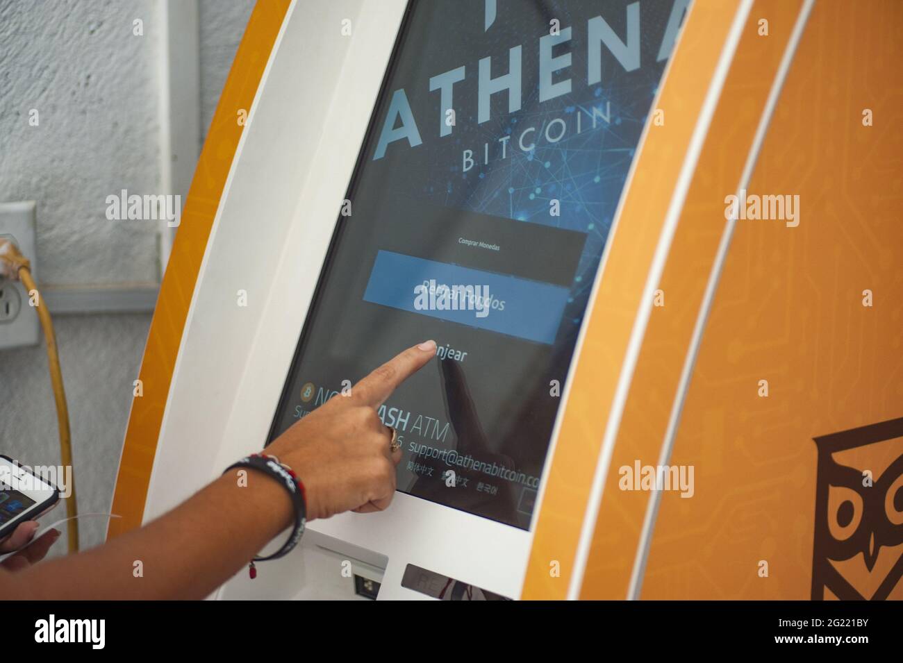 A woman withdraws money from a Bitcoin ATM. Salvadoran President Nayib  Bukele has announced that he will propose a law to the Congress, where his  party controls a majority, for Bitcoin to