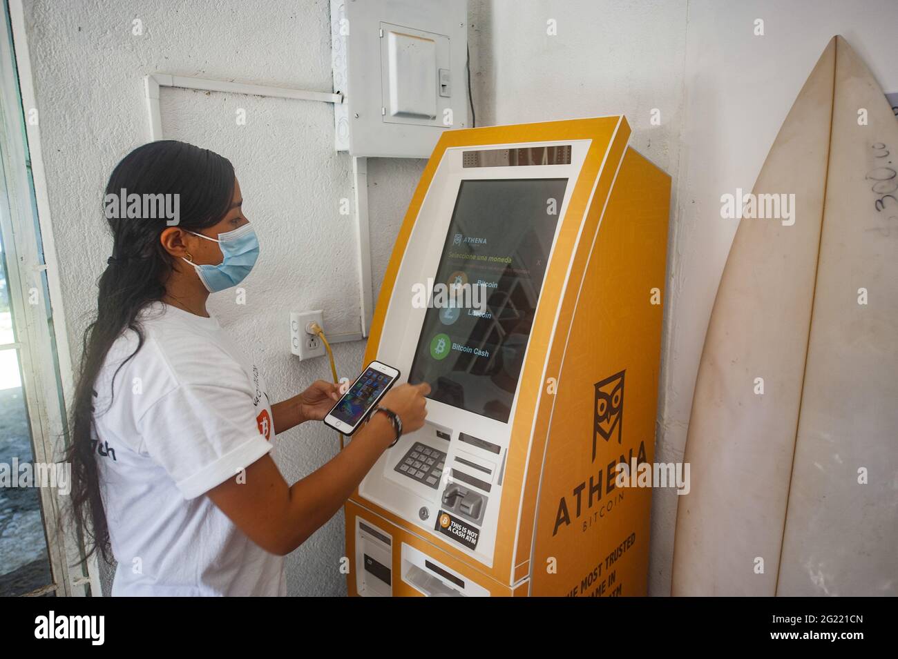 Chiltuipan, El Salvador. 07th June, 2021. A woman withdraws money from a  Bitcoin ATM. Salvadoran President Nayib Bukele has announced that he will  propose a law to the Congress, where his party
