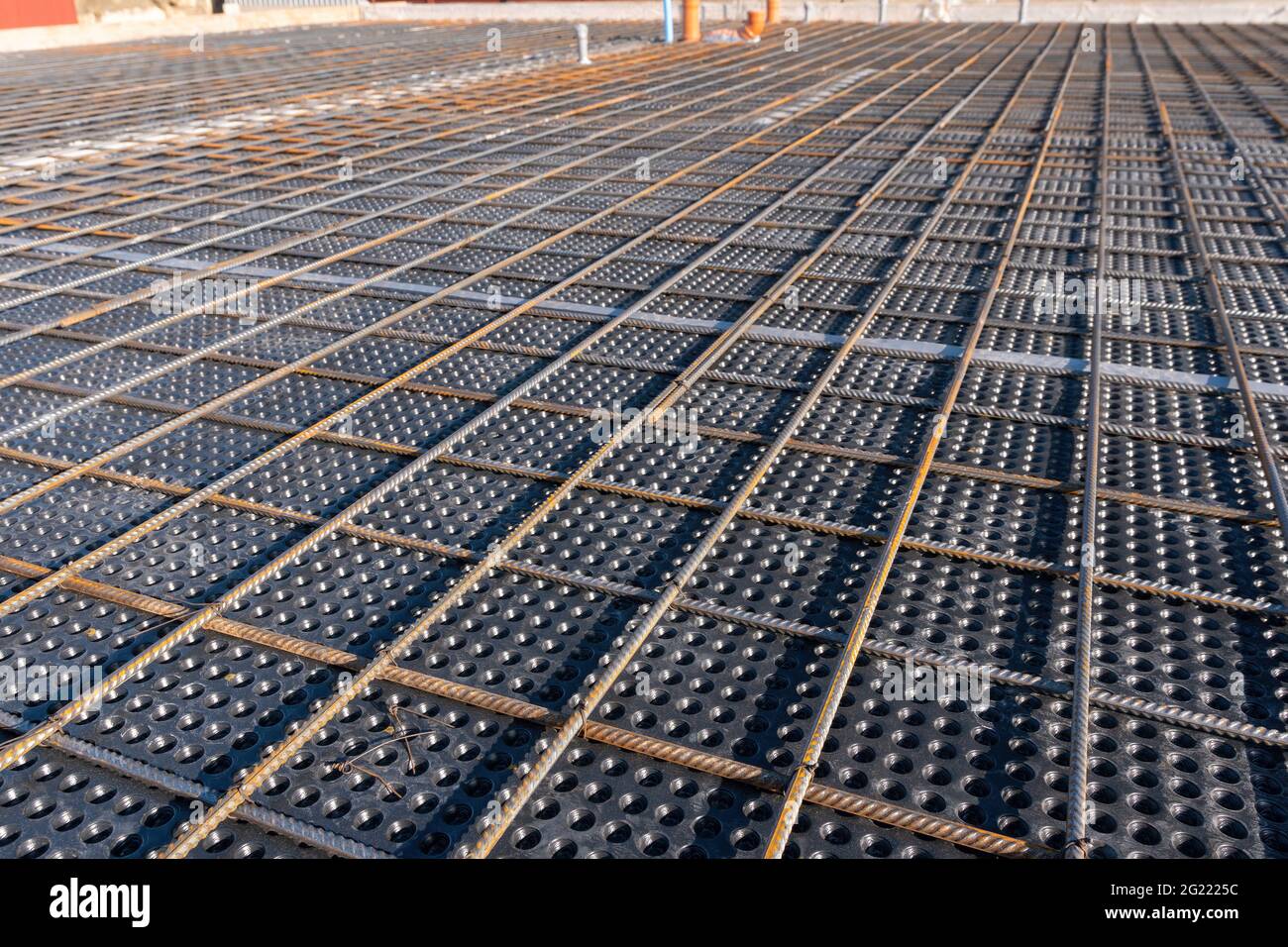 Close up view of reinforcement of concrete. Geometric alignment of Rebars on construction site. Reinforcements steel bars stack. Stock Photo
