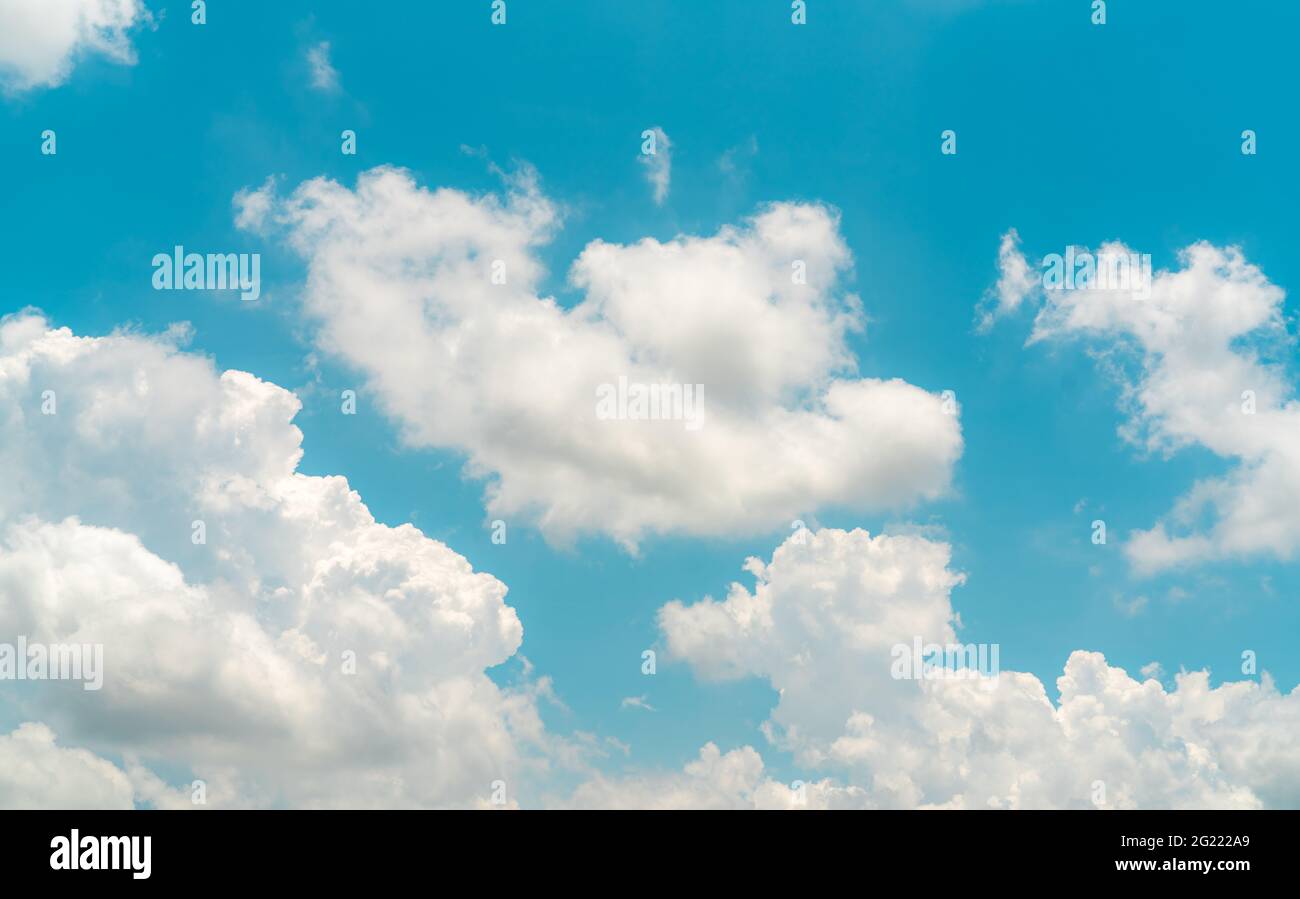 White fluffy clouds on blue sky. Soft touch feeling like cotton. White puffy cloudscape. Beauty in nature. Close-up white cumulus clouds texture. Stock Photo