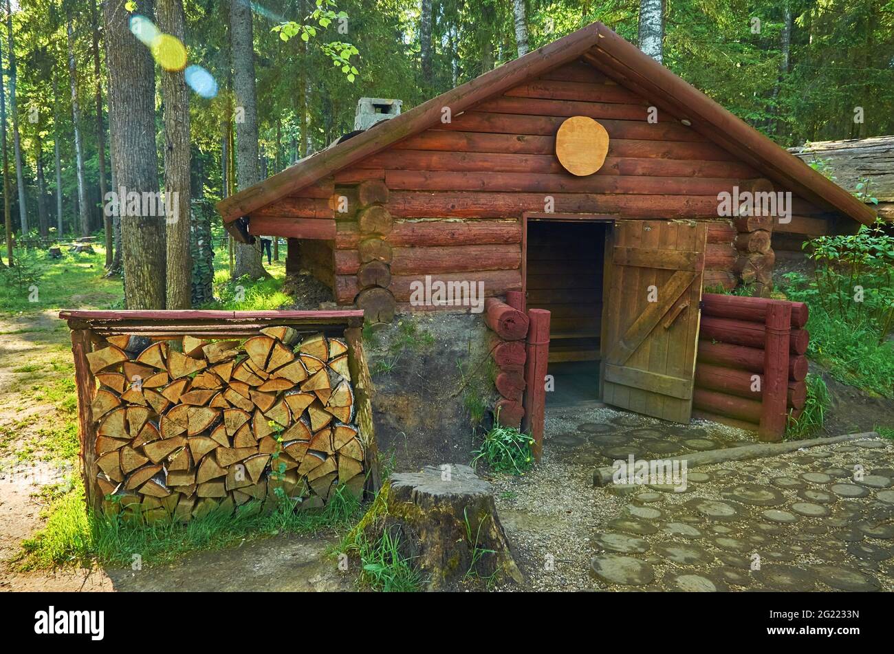 Old wooden dugout and wood storage in the forest Stock Photo