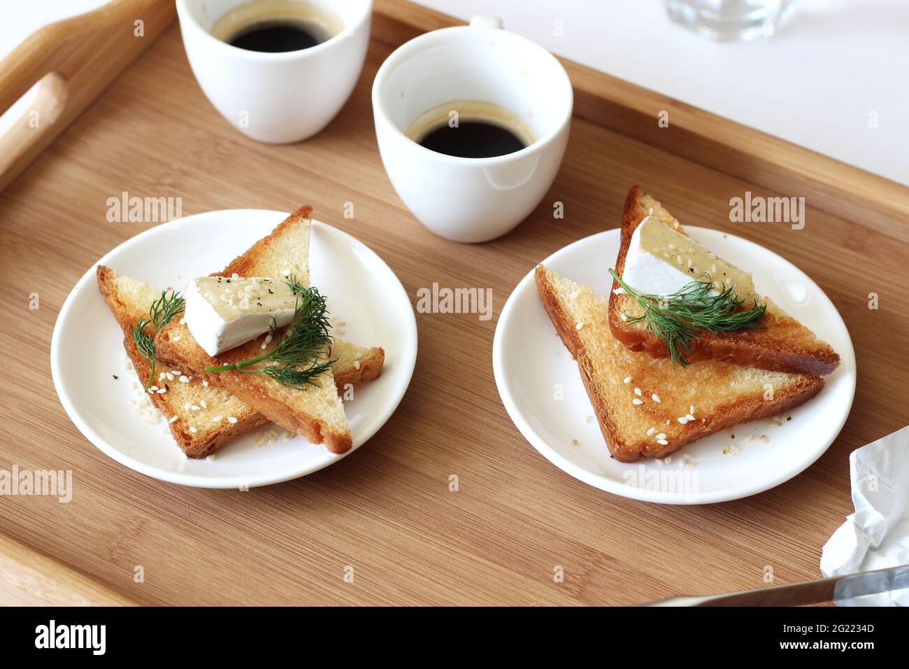 French Camembert Cheese on Fresh Crispy Toasts with Brewed Coffee. Breakfast at Home. Stock Photo