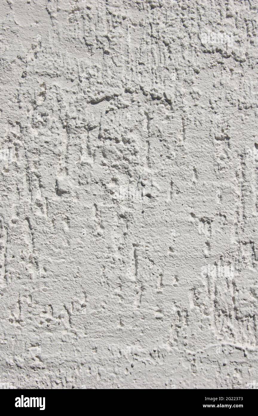 Wall grunge texture. Grey uneven wall surface. Whitewashed wall Stock