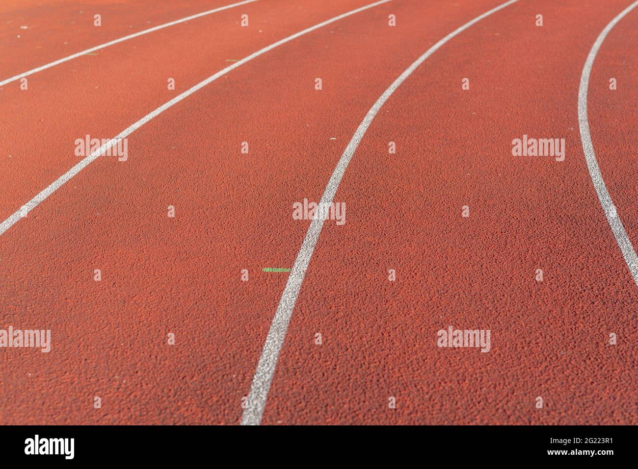 Part Red plastic track in the outdoor track and field stadium.Closeup. Stock Photo