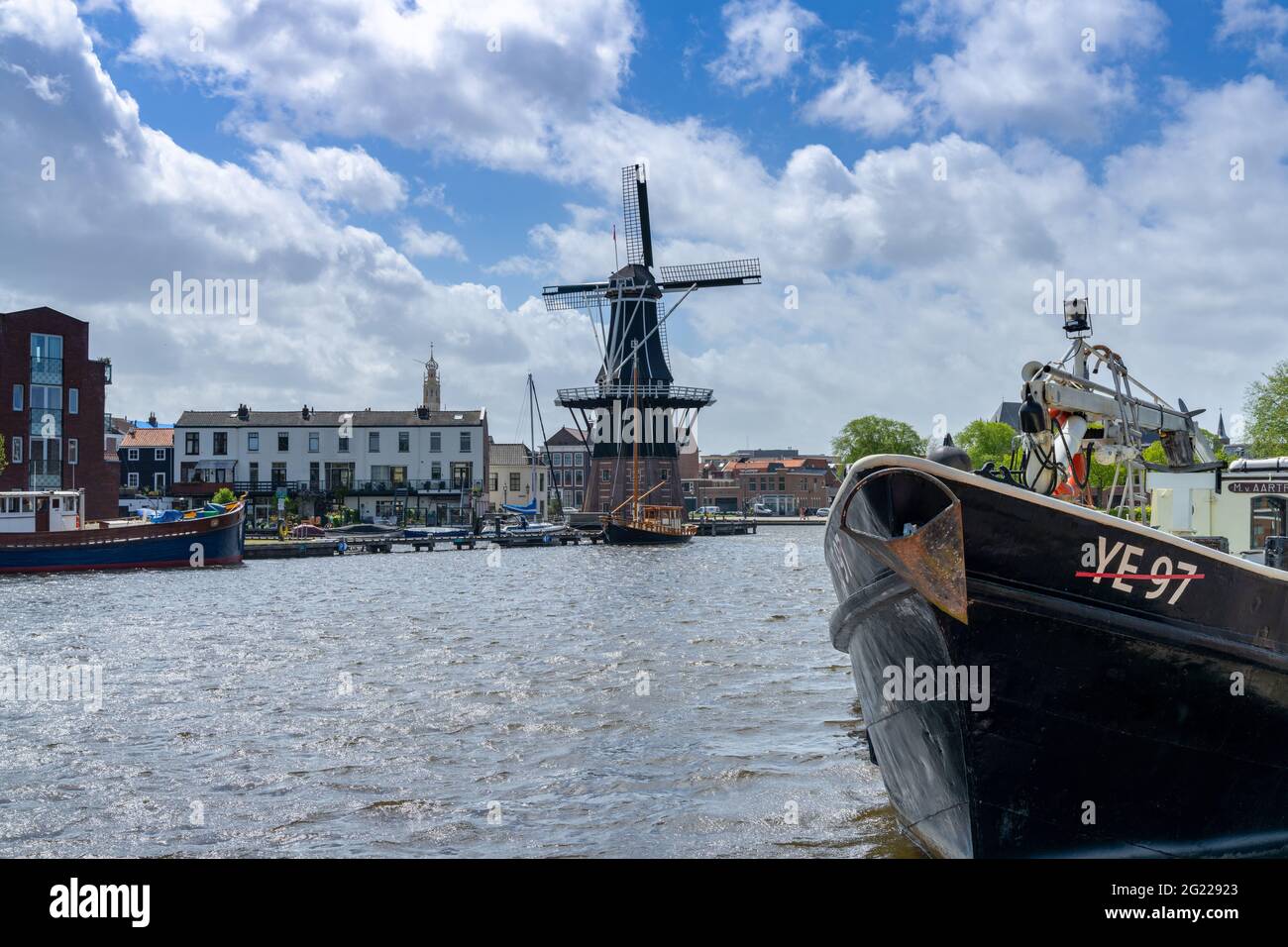 Haarlem, Netherlands - 21 May, 2021: view of the Dee Adrian Windmill and Binnen Spaarne River in Haarlem Stock Photo