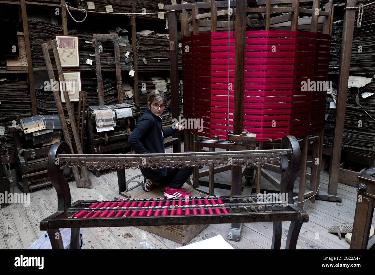 A female worker at the historical handcrafted weaving Luigi Bevilacqua, they produce fine fabrics for furniture and high fashion, in Venice, Italy Stock Photo