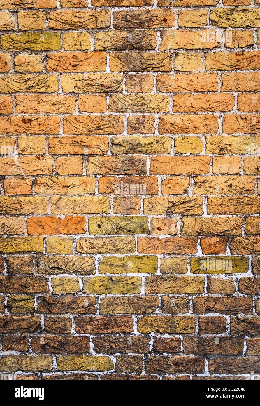 Yellow brickwall with rough textured surface Stock Photo