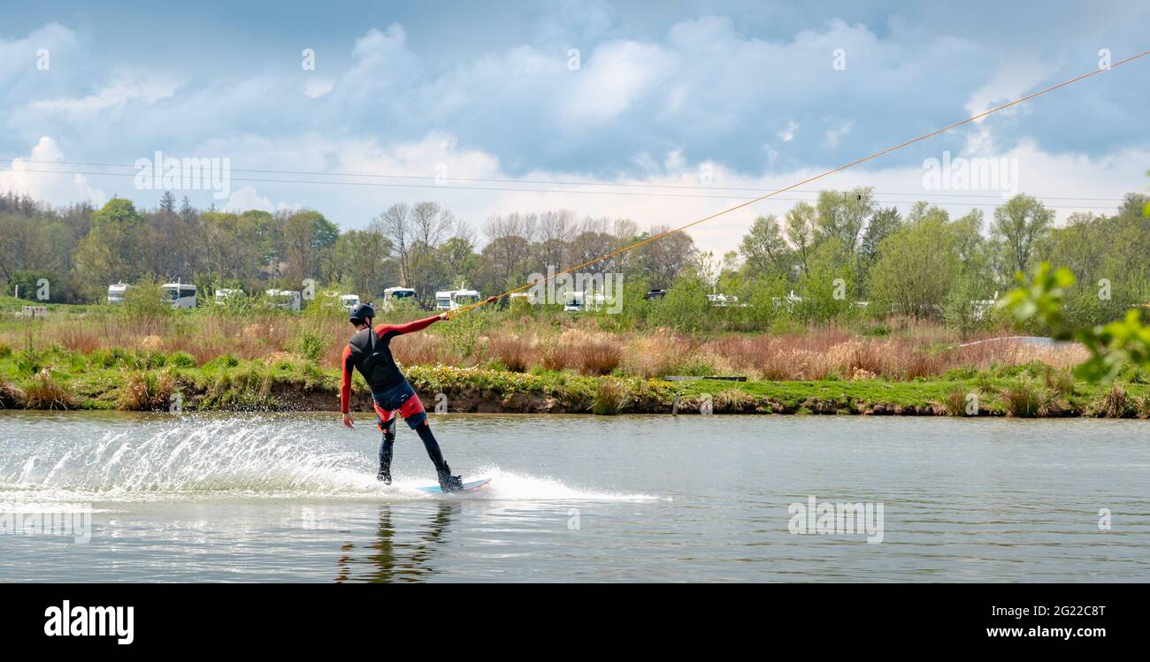 Man on waterski from the side, pulled by a lift Stock Photo