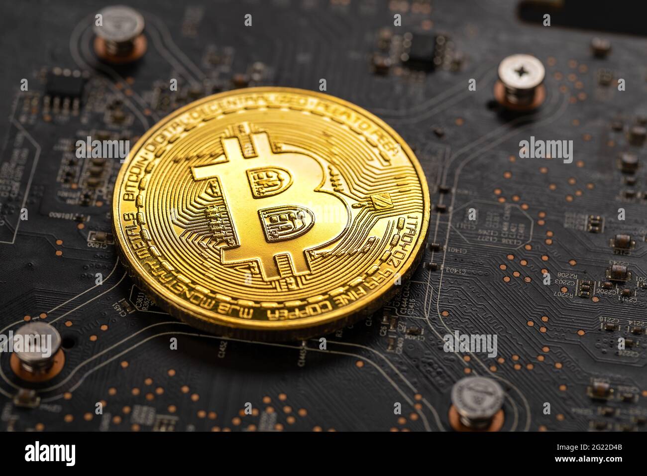 Gold bitcoin on crypto mining GPU circuit board computer hardware Stock Photo