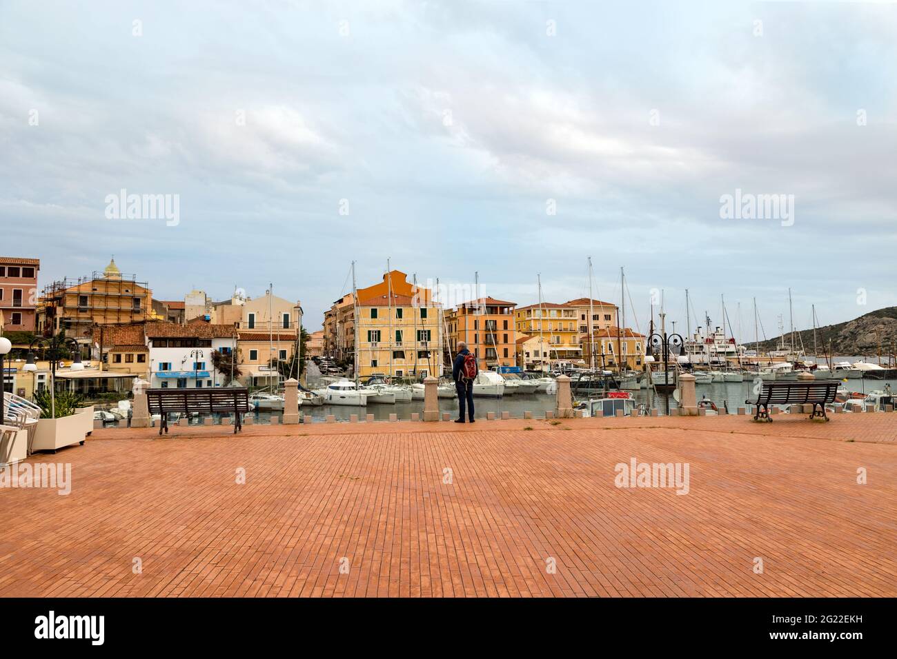 Tourist looking at the colorful Mediterranean architecture of La Maddalena on La Maddalena Island, La Maddalena Archipelago, Sardinia, Italy. Stock Photo