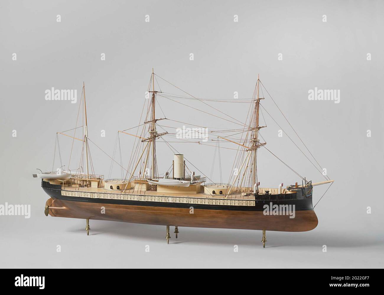 Model of An IronClad Ram Ship. Polychromed and witnessed block model of a ram tower vessel, the base board is missing. It has the national arms on a bow and mirror. The model has a ramsteven, a sharp cruiser gate, stir with rounded sheet, two double-leaf screws. It has two dome with two pieces each; There are two deck stores on the stern, connected by running corridors, two between the two domes, also connected by walking corridors, a deck house by the bow. The railing can be lowered before shooting. The chimney stands on the front deck house between the domes, part of the railing there has ca Stock Photo
