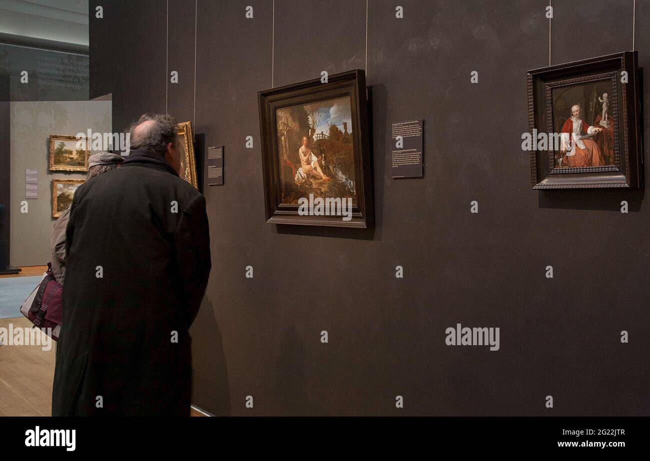 Two visitors for a wall with three paintings; Exhibition Gabriël Metsu