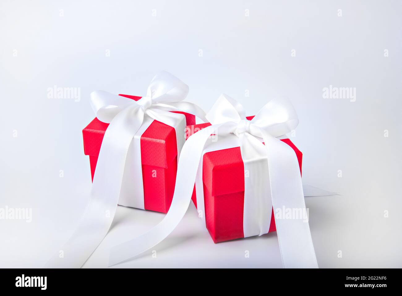Two red gift boxes with white bows. Stock Photo