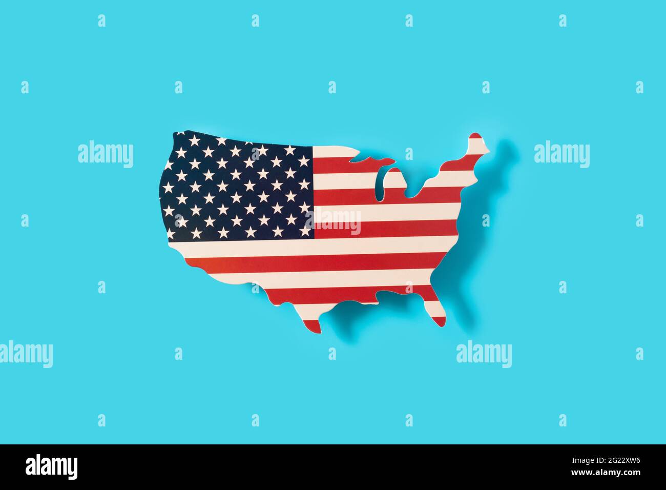 American flag on a map of the USA on blue background Stock Photo