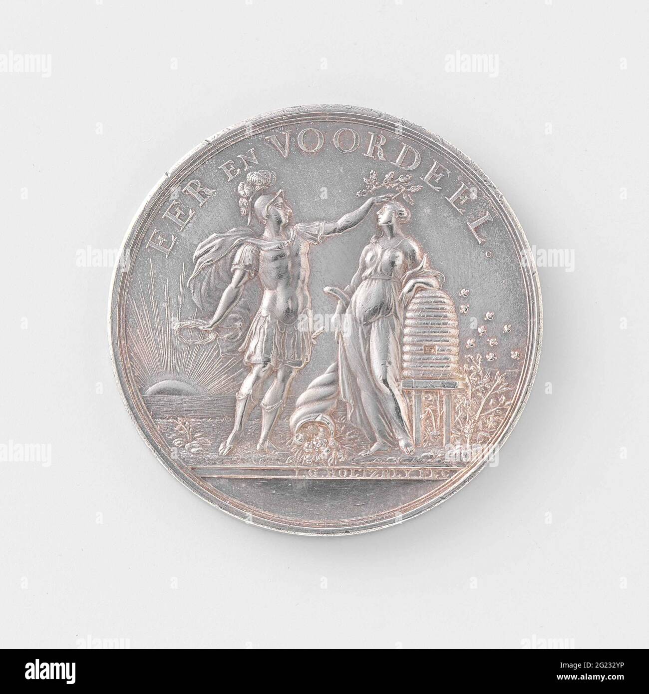 Oeconomic branch of the Hollandsche Maatschappij der Sciences, Penning awarded to Jan Timmerman from Haastrecht. Silver medal. Front: man in Roman clothing, presenting patriotic love, holds a laurel wreath in his right hand and puts his other hand oak wreath on the head of industry, who loves horn of abundance and leans against Bijenkorf; In background ascending sun inscription. Downside: inscription within laurel wreath and writing Stock Photo
