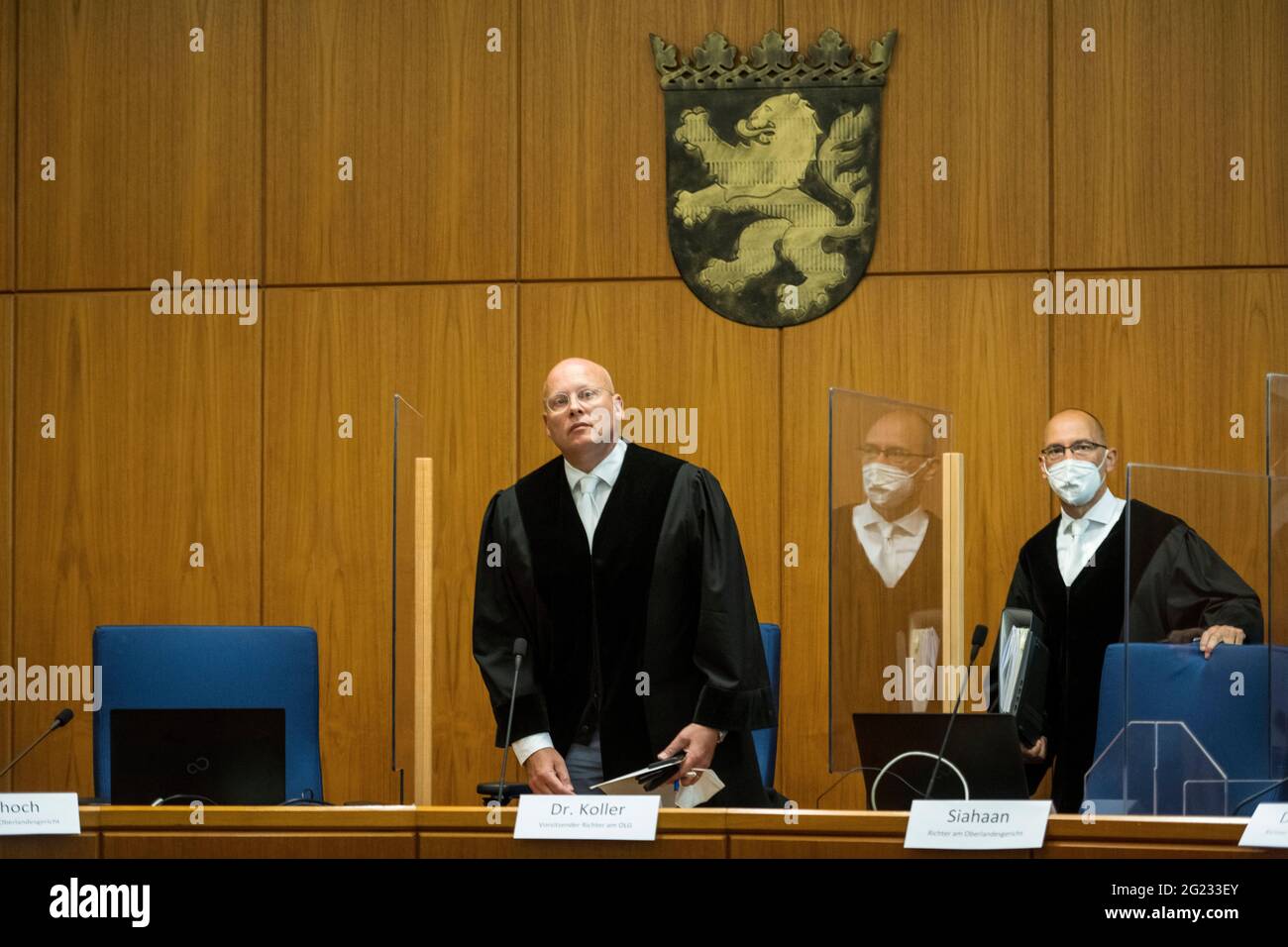 08 June 2021, Hessen, Frankfurt/Main: Presiding Judge Christoph Koller (l) arrives for the third day of the trial against Franco A. at Frankfurt Higher Regional Court (OLG). The defendant is alleged to have procured weapons for alleged right-wing extremist motivation in order to carry out attacks. According to the indictment, he posed as a Syrian in order to draw suspicion to refugees. Photo: Thomas Lohnes/Getty Images Europe/Pool/dpa Stock Photo