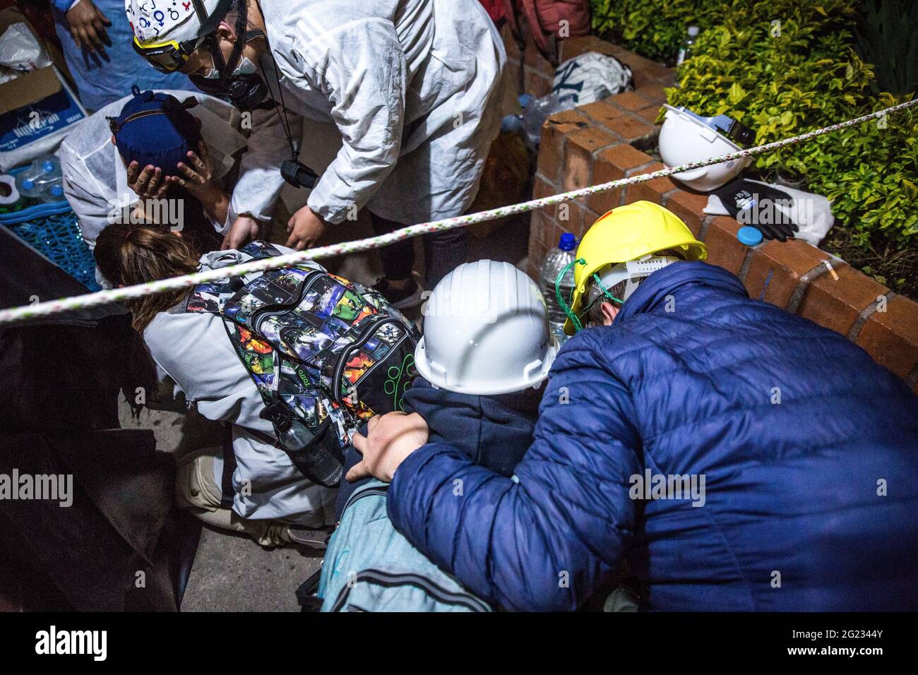 Protesters receive medical attention after multiple attacks with tear gas fired by the police during the demonstration.On the 4th of June, the Colombian Government ordered demonstrators to dismantle the voluntary medical camp at the 'American Gate' renamed 'Resistance Gate' in Bogota. In response to this, human rights organizations asked the Mayor of Bogota to give them an another location to set up the medical camp. They did not get an answer and instead got attacked by the anti-riot police during the evening. Protesters were shot at with tear gas canisters, stun grenades and water cannons. Stock Photo