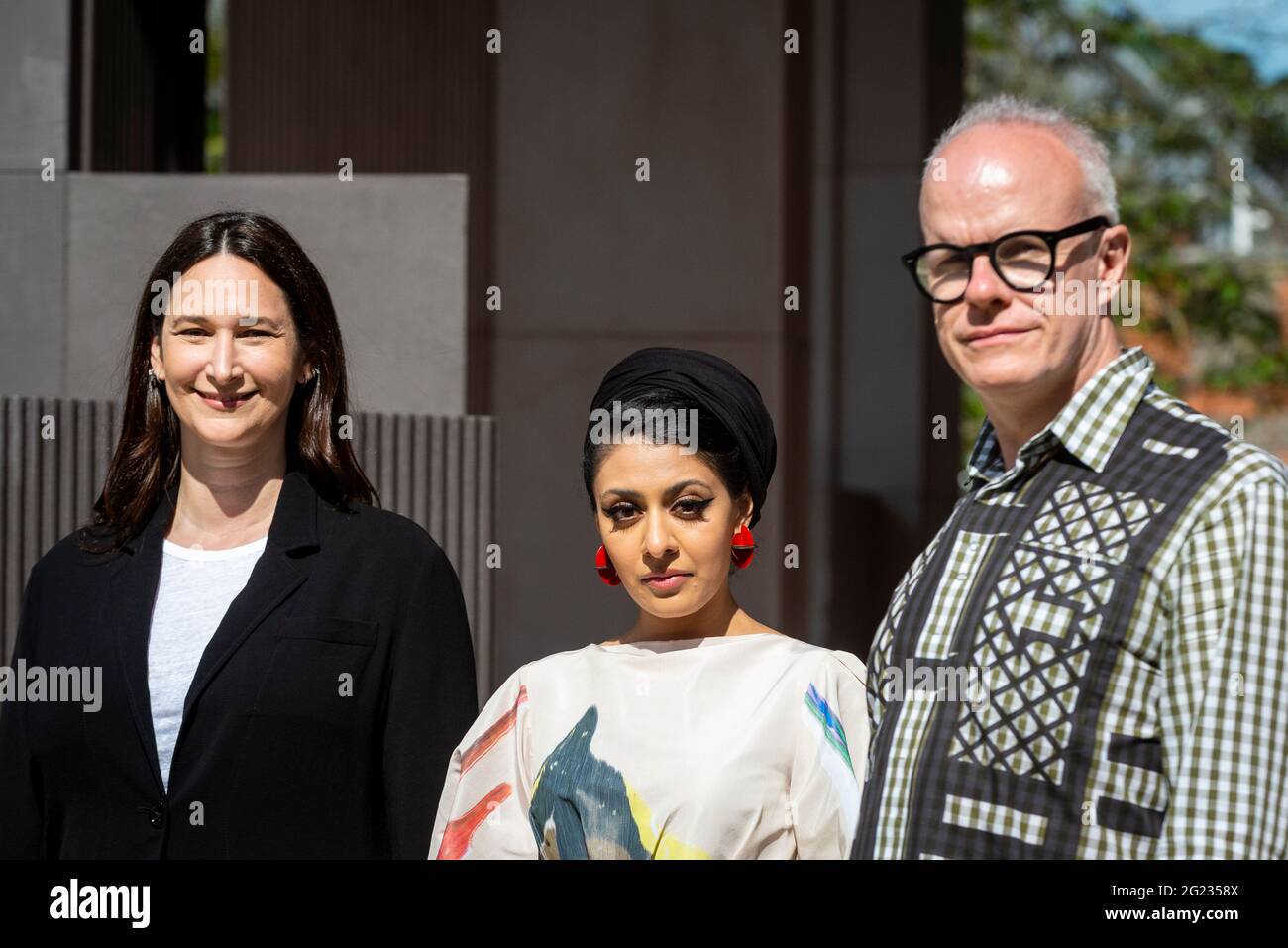 London, UK.  8 June 2021.  (L to R) Bettina Koprek, CEO, Serpentine, architect Sumayya Vally and Hans Ulrich Obrist, Artistic Director, pose at the unveiling of the 20th Serpentine Pavilion in Kensington Gardens. It is designed by Johannesburg-based practice Counterspace and directed by Vally, who is the youngest architect to be commissioned for this internationally renowned architecture programme.  The design references the architecture in migrant communities in some of London’s neighbourhoods and is on display 11 June to 17 October.   Credit: Stephen Chung / Alamy Live News Stock Photo