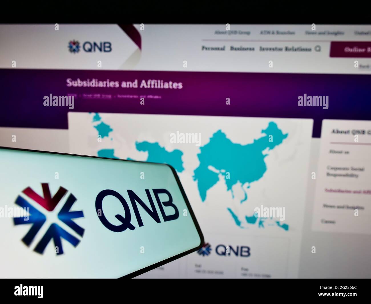 Mobile phone with logo of financial company Qatar National Bank Q.P.S.C