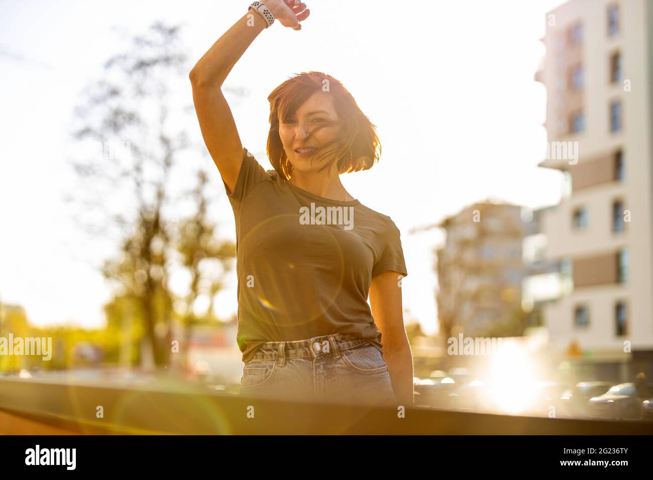 Portrait of smiling redheaded woman in the city Stock Photo