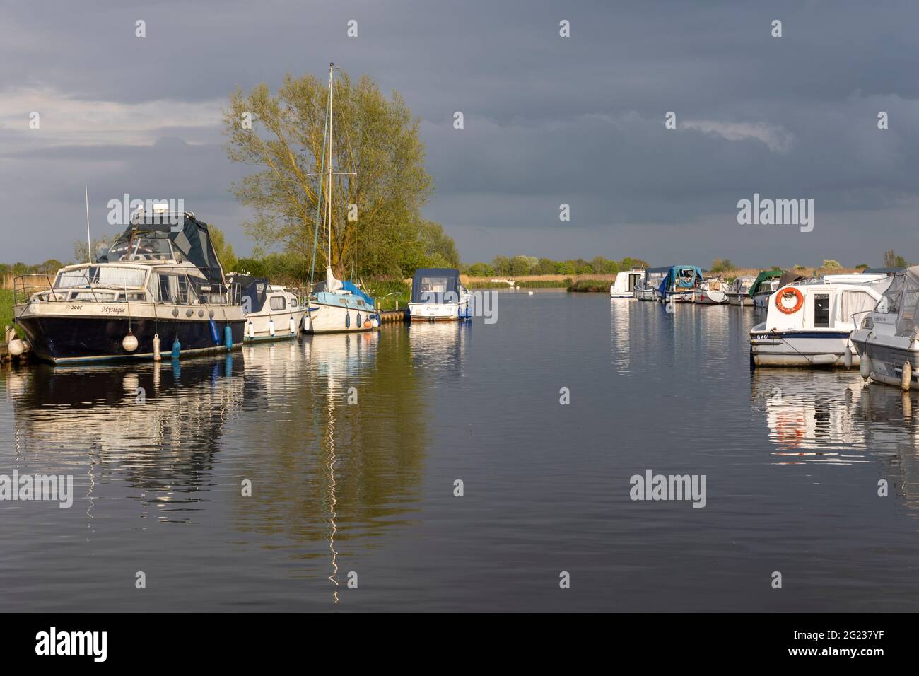 Moored boats and cabin cruises on the River Ant at Ludham bridge, Norfolk Broads Stock Photo