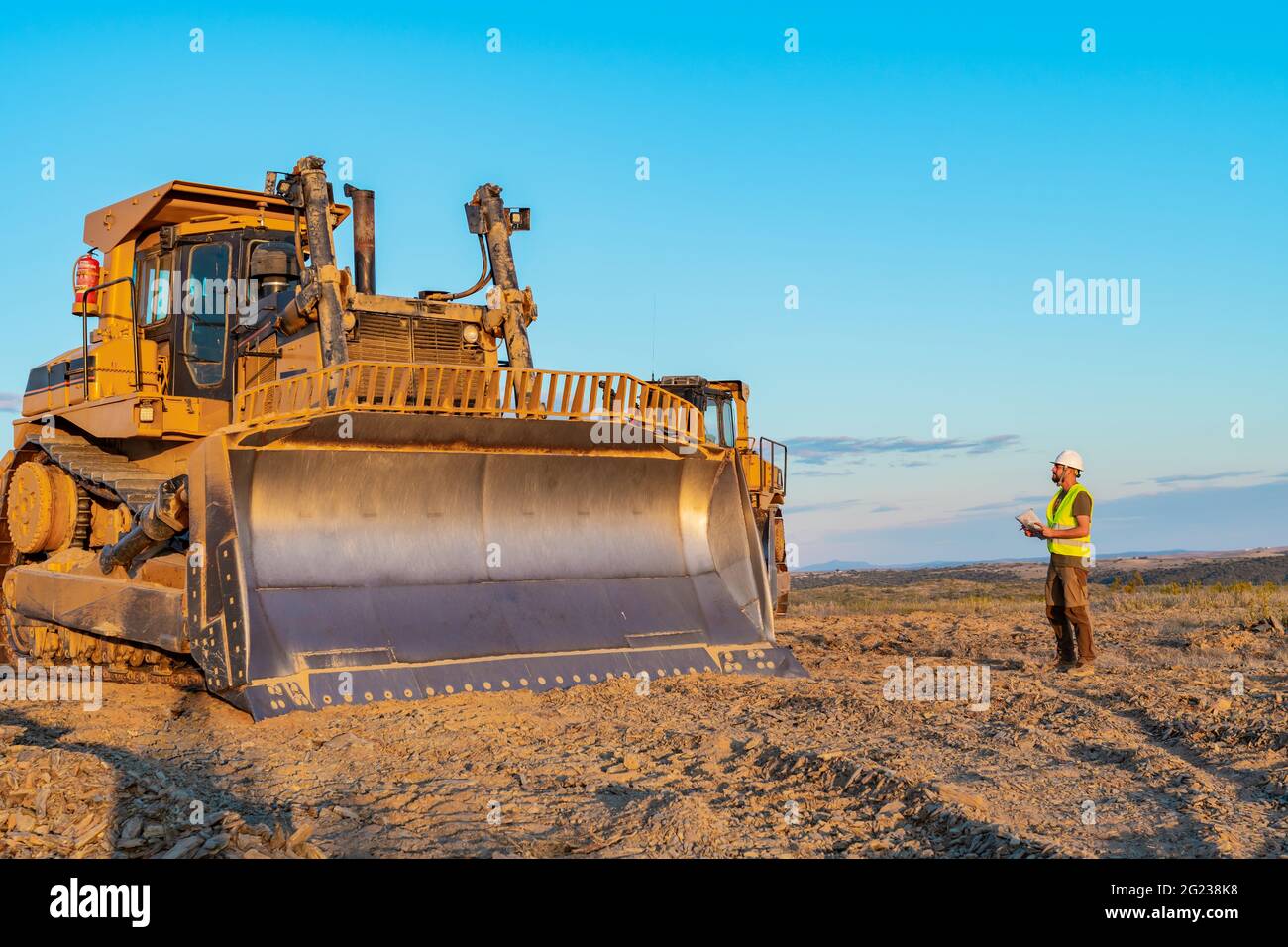 labor inspector with safety helmet and reflective vest inspecting a