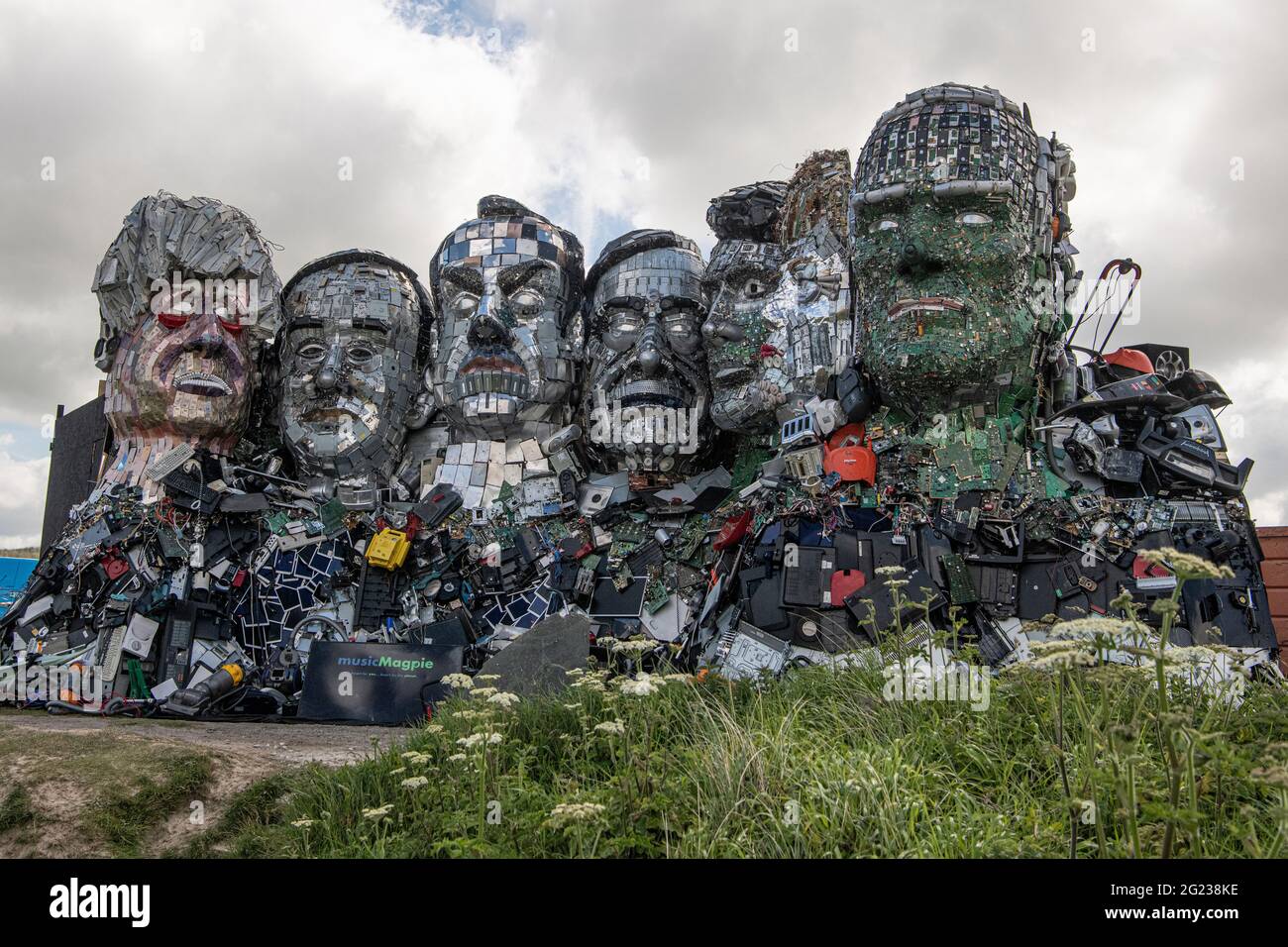 Carbis Bay, Cornwall, UK. 08th June, 2021. G7 Mount Recyclemore, 'Mount Rushmore', sculpture made of electronic waste is built on a beach in Carbis Bay Cornwall. Looking over the G7 summit, The seven faces definitely look like the world leaders who will be attending the G7 Summit this week. UK Prime Minister Boris Johnson, Japanese Prime Minister Yoshihide Suga, France's president Emmanuel Macron, Italian Prime Minister Giuseppe Conte, Canadian Prime Minister Justin Trudeau, German Chancellor Angela Merkel and US President Joe Biden. Credit: kathleen white/Alamy Live News Stock Photo