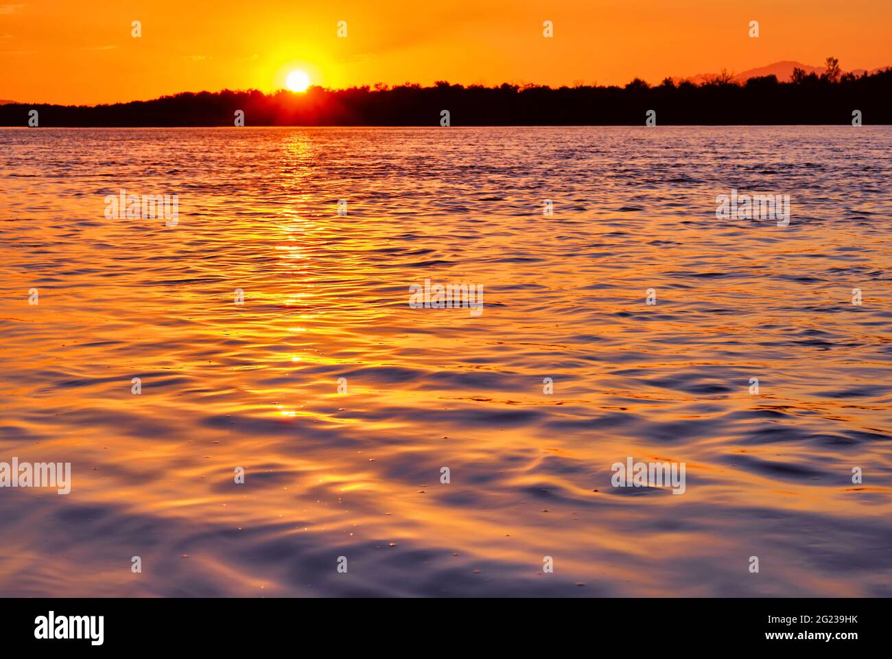 Soft sunlight of the setting sun on the waves; sunset on the river Stock Photo