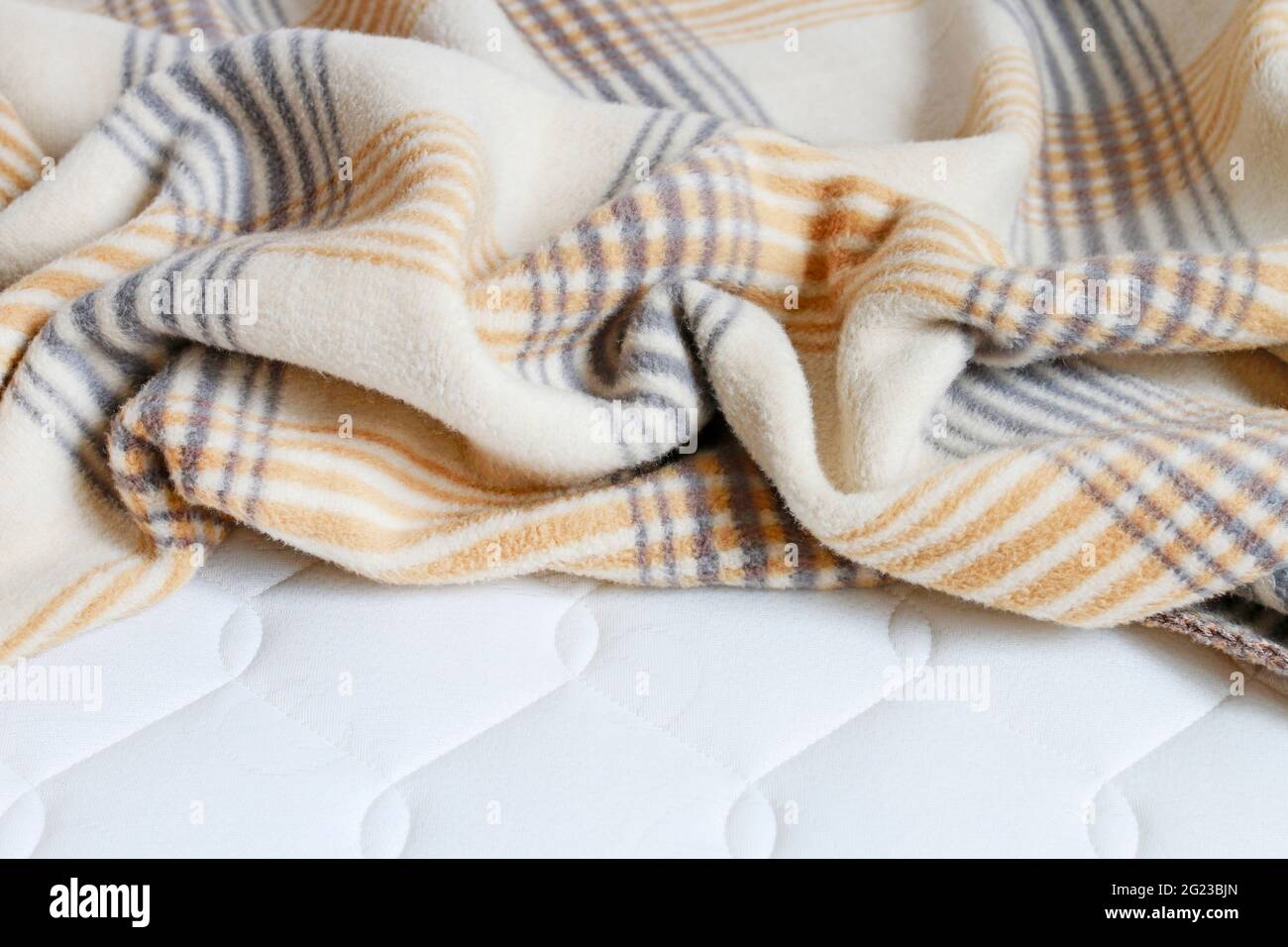 Beige blanket on the new mattress. Graphic resources Stock Photo