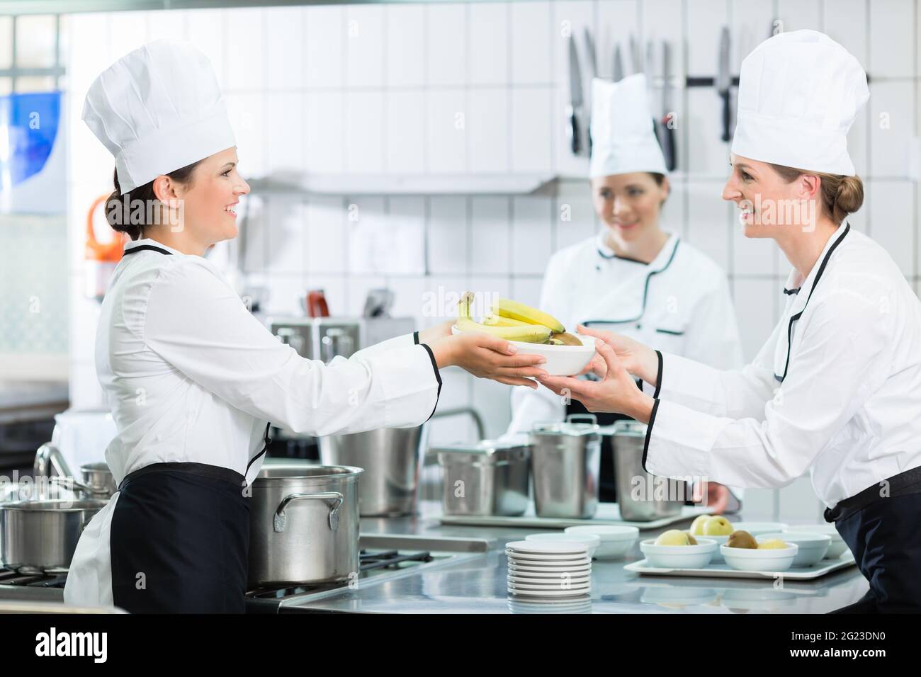 Kitchen brigade in catering kitchen preparing dishes Stock Photo