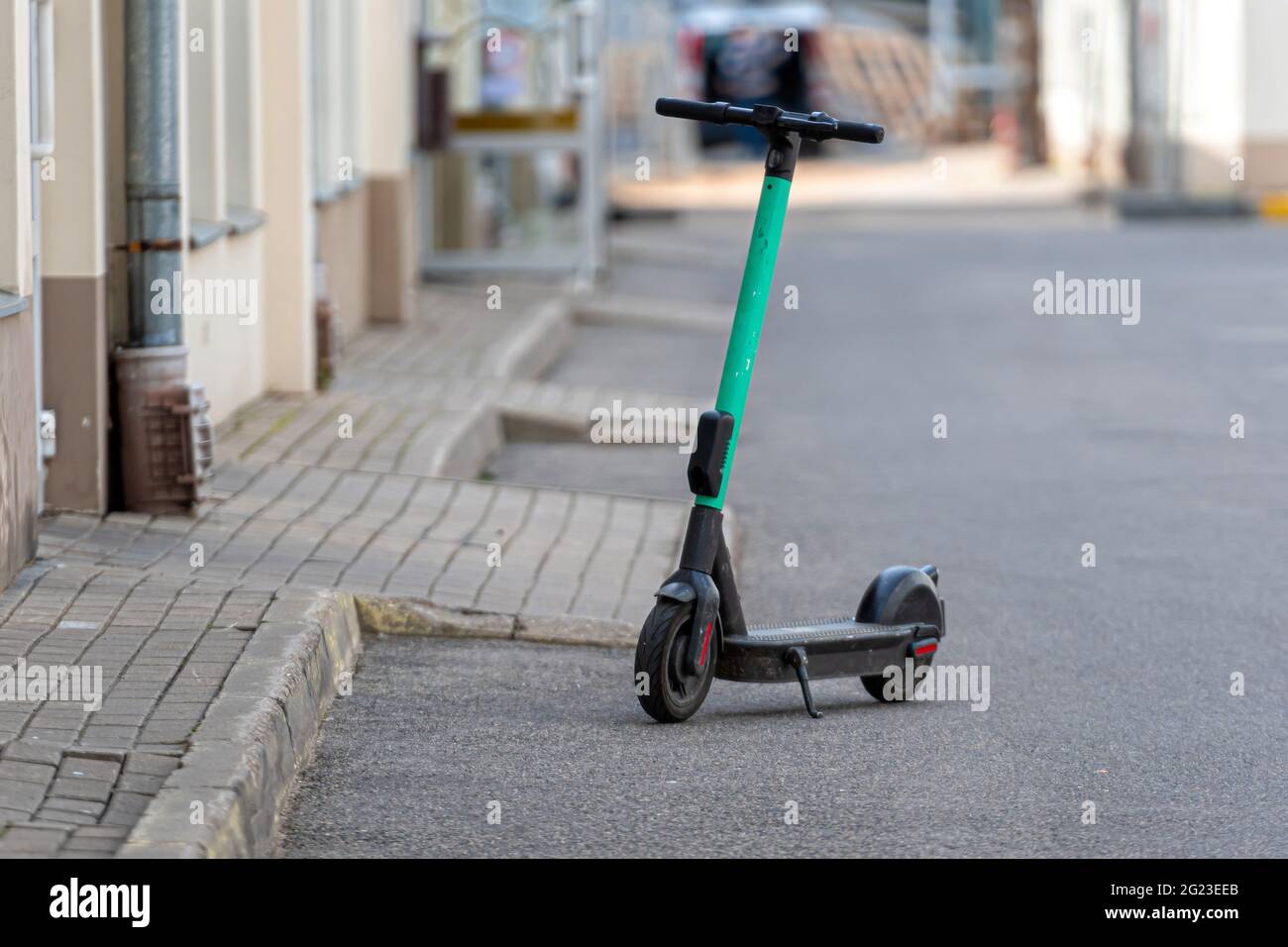 green e-scooter for rent parked on street, electric scooter for public  sharing, modern eco-transport Stock Photo - Alamy