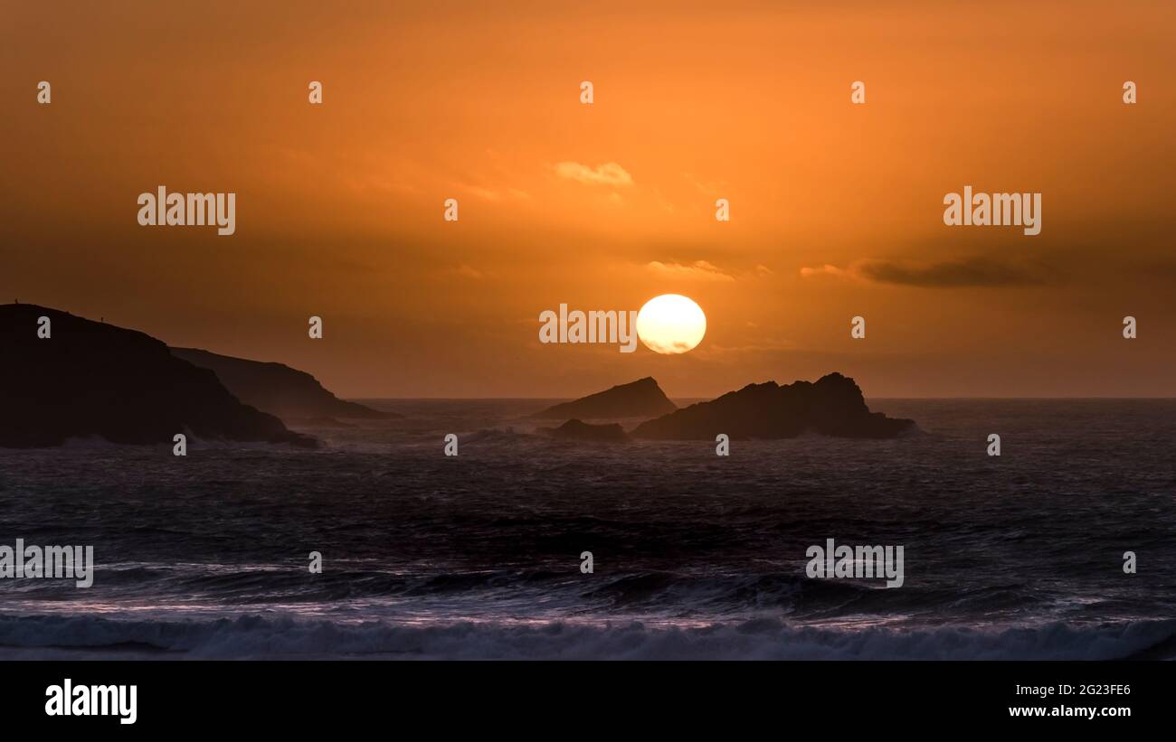 A panoramic view of an intense spectacular sunset over Fistral Bay in Newquay in Cornwall. Stock Photo