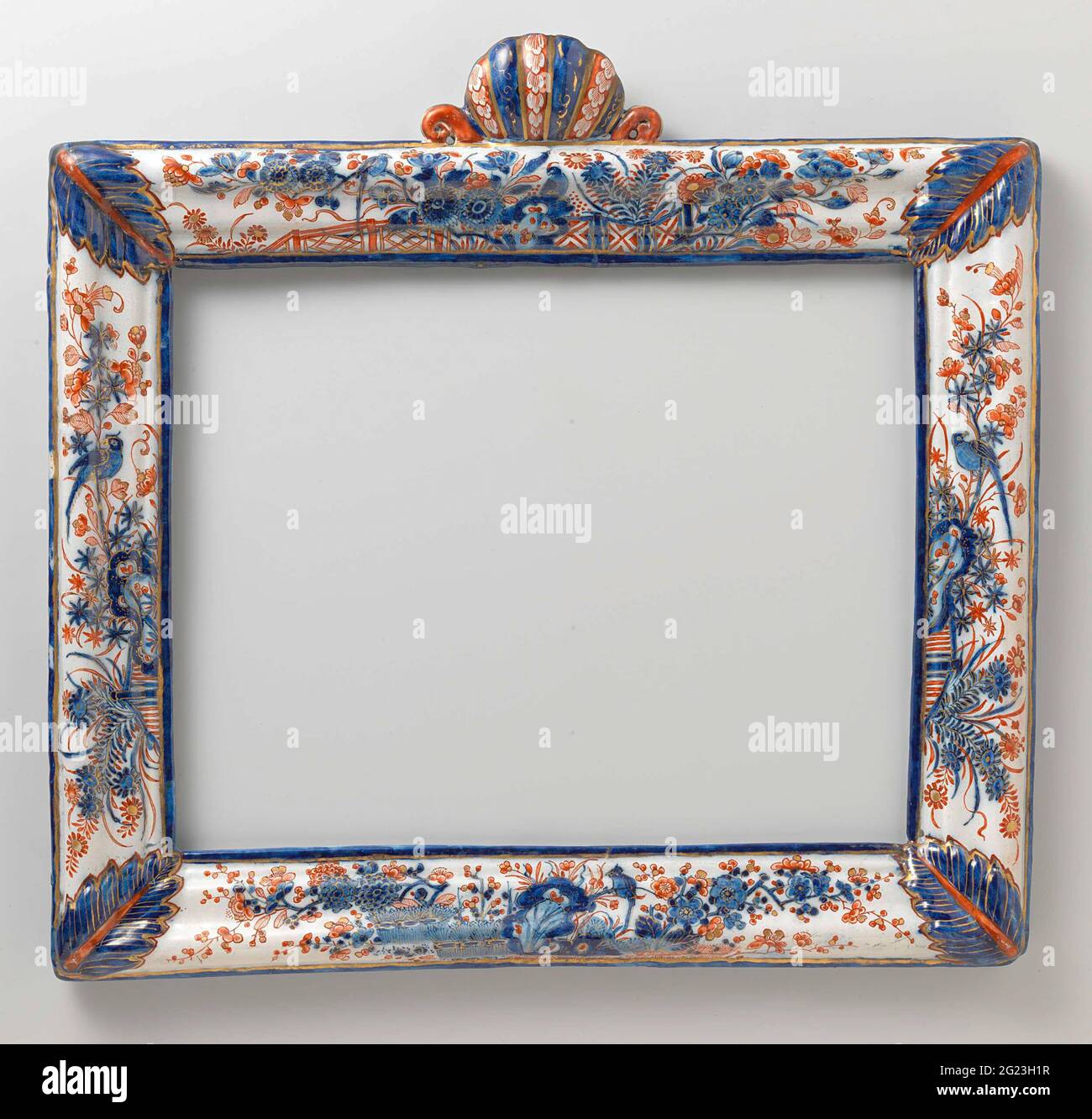 Furniture. Rectangular mirror list with profiled rules and styles with an acanthus sheet on the corners. The rules and styles are decorated with an Imii decor, consisting of rocks, gates bound hedges and flowering branches, on which birds in blue, red and gold. Inner and outer edge in blue with golden trim. In the middle of the upper rule a stuffed shell with a volute on either side. This attachment evens in blue, red and gold. Stock Photo