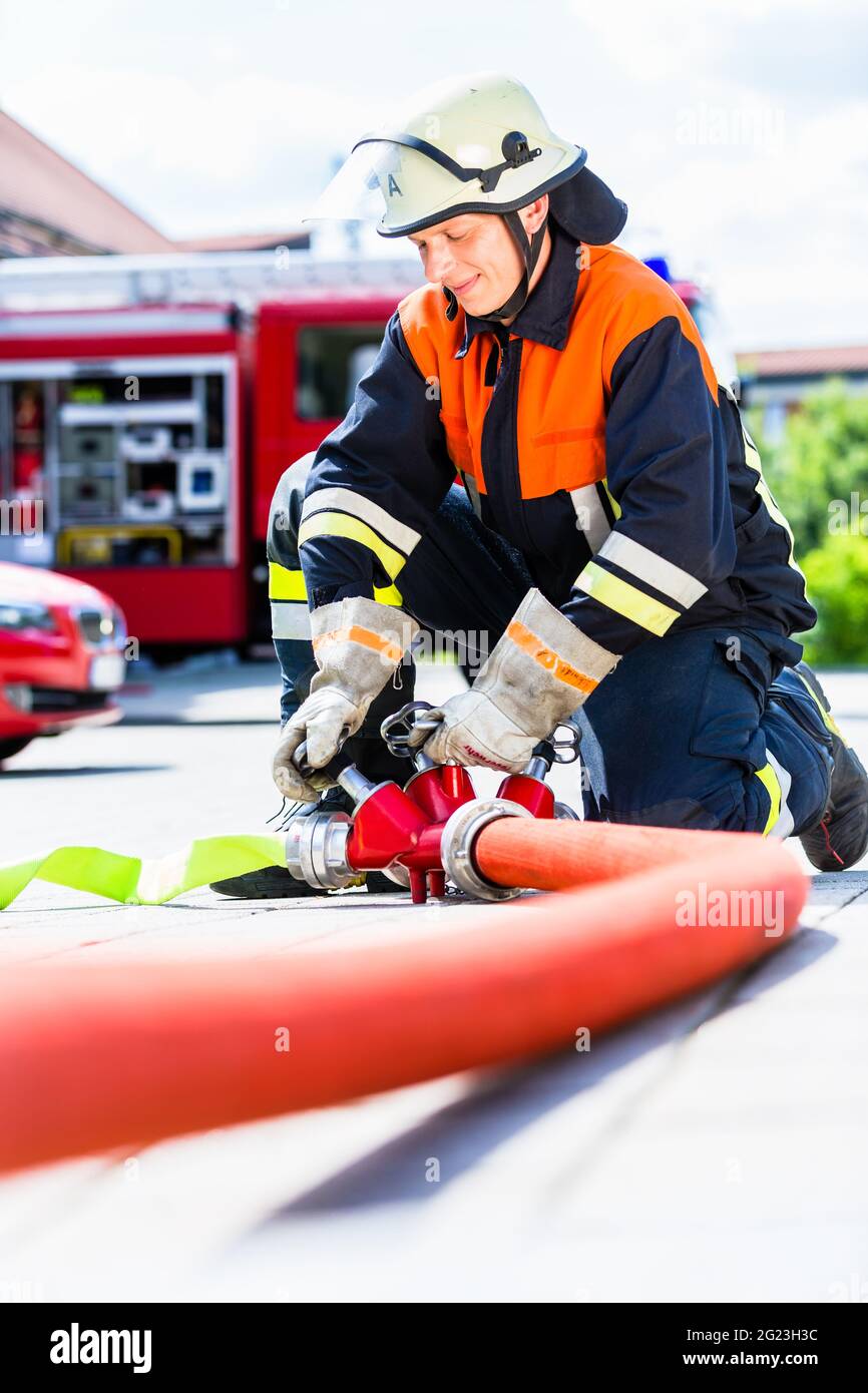 Fire department brigade action water hose hoses hi-res stock ...