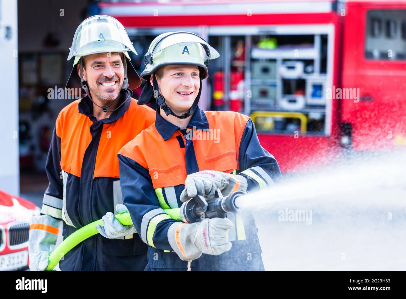 Fire fighters from fire brigade extinguish fire Stock Photo - Alamy