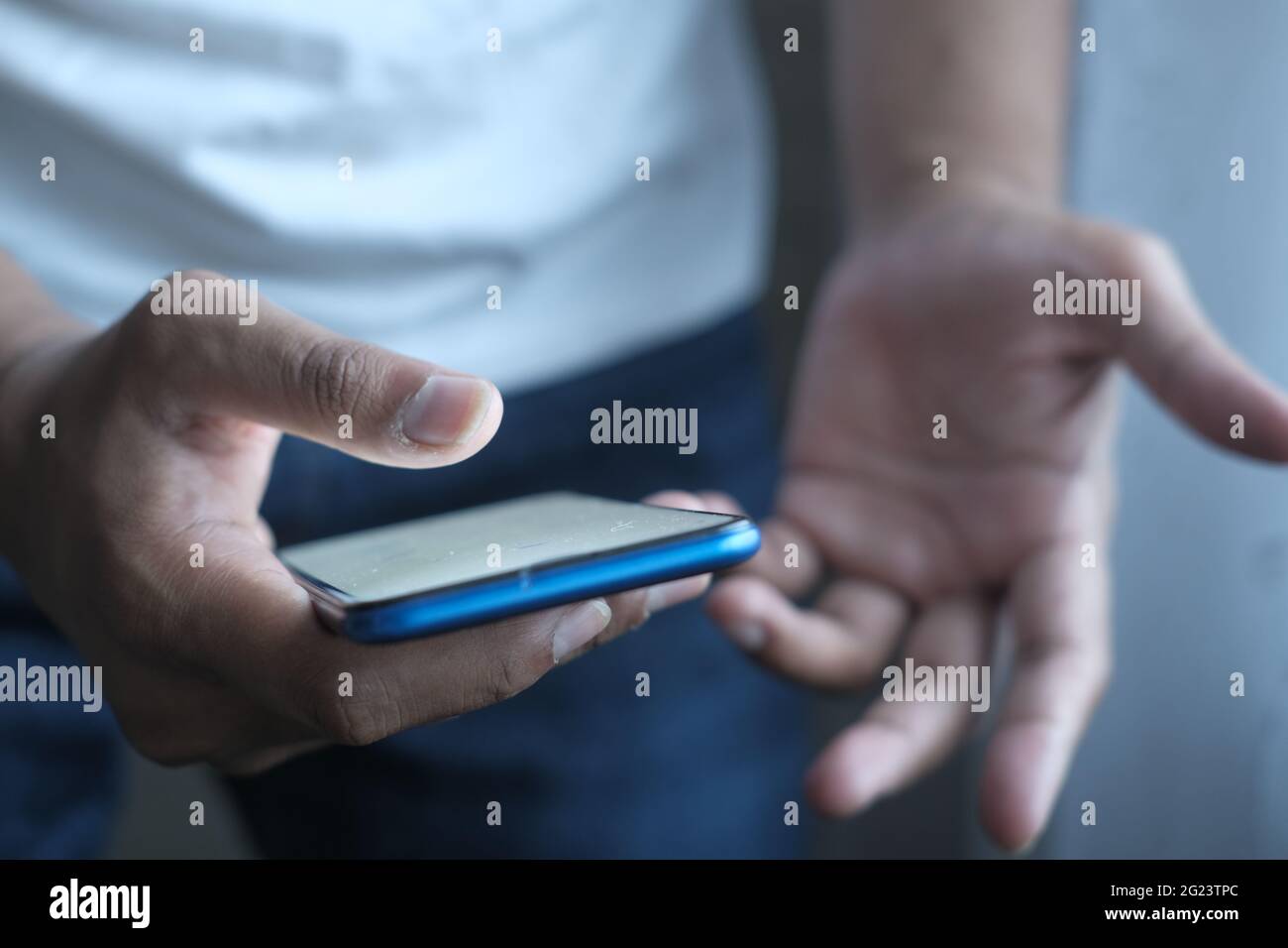 Close up of man's hand using smart phone at night Stock Photo - Alamy